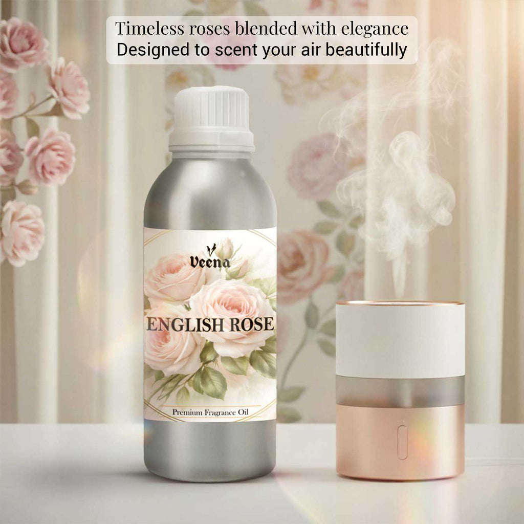 Veena English Rose Premium Fragrance Oil 500g bottle paired with an elegant pink and gold humidifier against a soft floral wallpaper background.