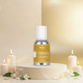 Veena Jasmine Fragrance for Candle Making bottle sitting centered on an upscale white display pedestal with ambient candles and white floral arrangements.