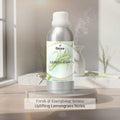 Veena Lemongrass Premium Fragrance Oil wholesale aluminum bottle sitting on a stone riser next to a working room humidifier.