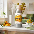 Veena Mandarin Premium Fragrance Oil wholesale aluminum bottle displayed on a white table next to a working humidifier and fresh mandarin oranges.