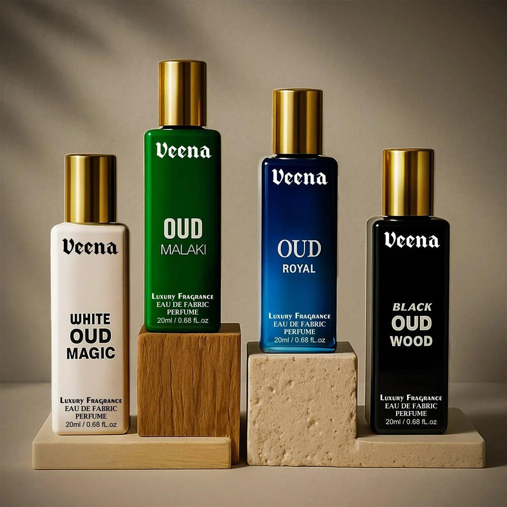 Veena Luxury Oud Fabric Perfume set with White Oud Magic, Oud Malaki, Oud Royal, and Black Oud Wood on aesthetic display blocks.