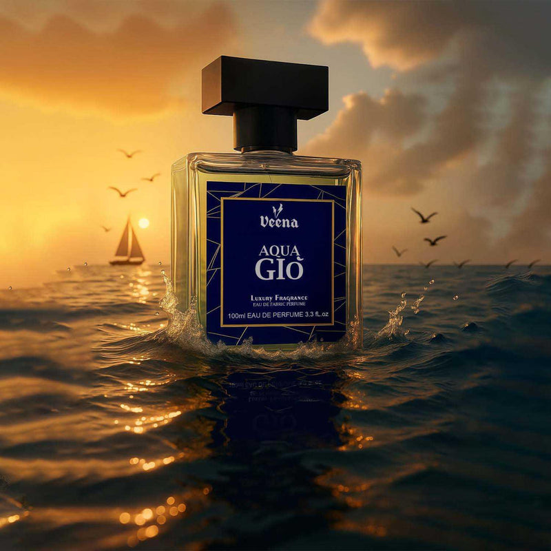 Veena Aqua Gio luxury fabric perfume bottle splashing on ocean water surface with sunset background